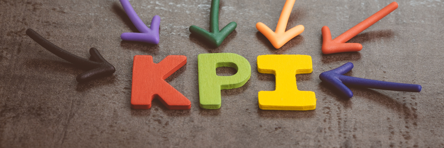 Header for "Four KPIs to Boost Your Major Gifts Program" - Wooden Letters on a Table that Spell Out KPI with multicolored clay arrows pointing to the word.