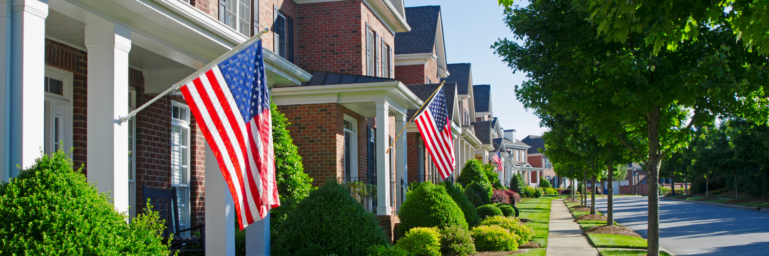 Fundraising Lessons from the Best Neighborhood in America, image shows two story brick homes all in a row with american flags flying off their porches